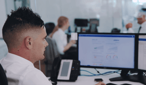 Automotive staff looking at SalesLogs software on a computer