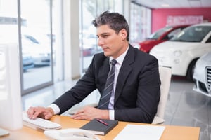 Car salesperson reviewing dealer analytics and his performance