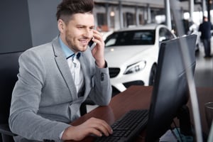 Car salesperson using an automotive business intelligence platform to help a customer over the phone